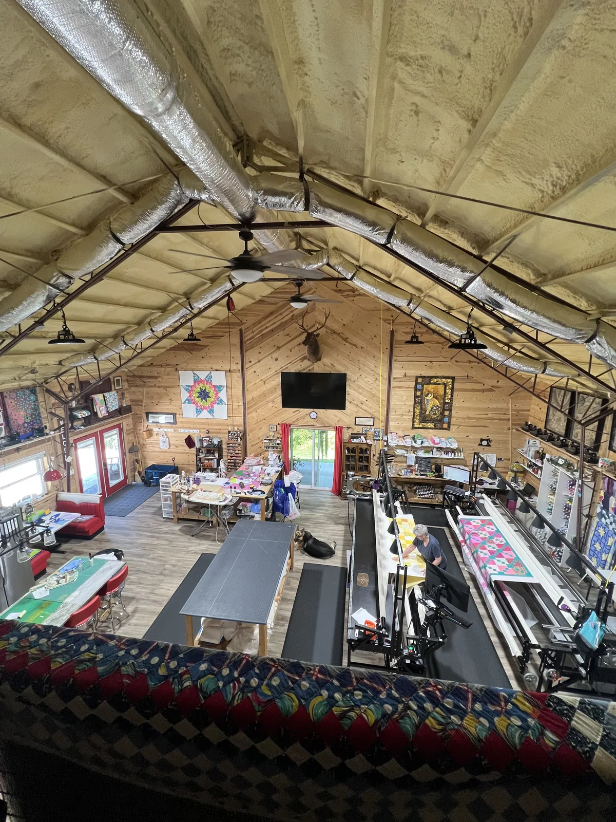 Overhead view of Debbie working in the Frankenstitch quilting studio